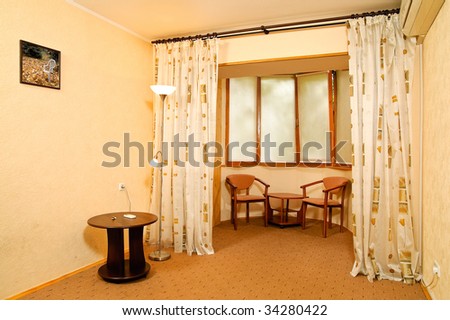 Balcony with chairs and table. Photo in the frame made by the author