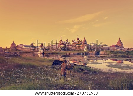 The artist paints a picture of nature at sunset with the castle in the background