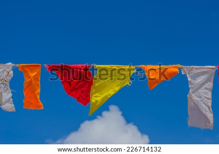 colorful festive bunting flags against a blue sky background