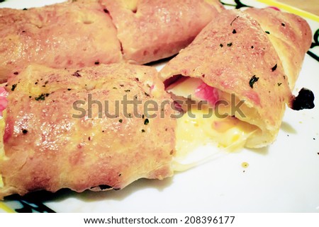 A cut in  pieces of pizza rolls with Ham and Cheese