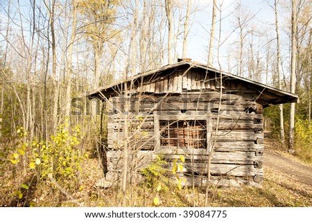cabin or small log home, abandoned and in need of repair on a right fall day