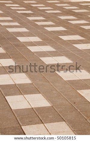 interlock brick in grey and white colors with sand stains
