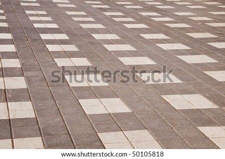 Interlock brick in grey and white colors with brown sand stains