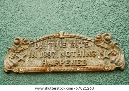 historic metal plaque on painted wall