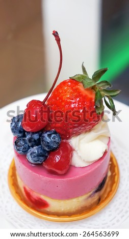 Fruit dessert with berries (berry cheesecake with blueberries, cherry, and strawberries)