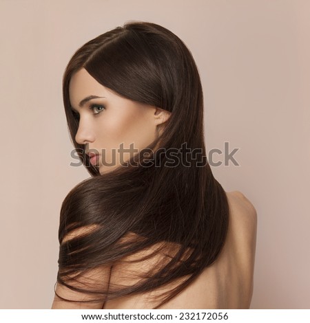 Beautiful young woman with long healthy brown hair and perfect skin