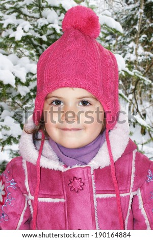 Cute little girl or toddler dressed up in pink winter gear to play outside