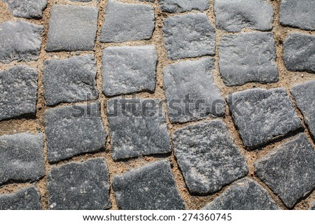 Royal ancient paving, texture and background. Sidewalk street paved with ancient cobblestones. Historic bridge in St. Petersburg.