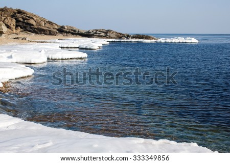 Ice Floe, Icy shore of the sea,  North sea, cold sea of the North, winter ice, white snow of the Arctic, Arctic ocean. Beach at the winter ocean. Spring Arctic. Melting of ice