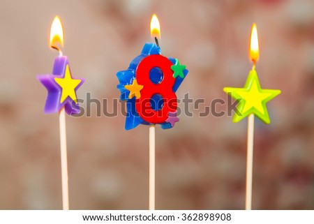 The candles on the cake. Birthday. 8 years. Birthday cake. Sweet Birthday cake. A children\'s holiday. Dessert for children. Food symbol. A cake with candles.