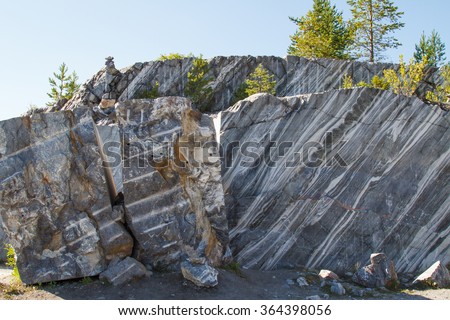 Marble quarry, marble rocks in the wild in the Republic of Karelia. The natural stone. Ancient Marble quarry, marble rocks in the wild. Slices of marble mountain. Tourism and travel.