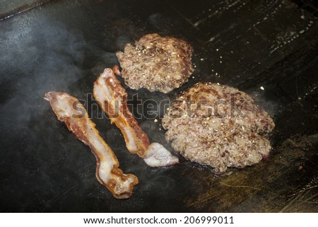 two hamburger steaks and two slices of bacon