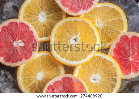 Yellow orange and blood red grape, on a stone plate