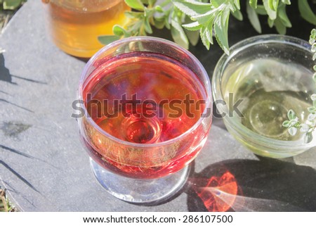 A Glass of red wine vinegar, between glass of apple and white wine vinegar