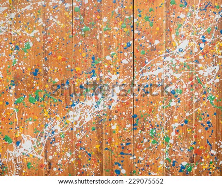 Mixed color splatter on wood wall background