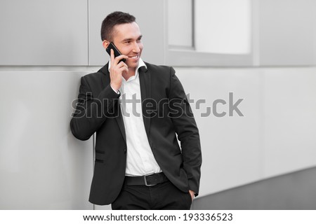 Young happy man talking on mobile phone
