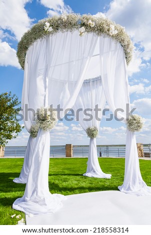 Wedding setting on a green lawn. Wedding arch