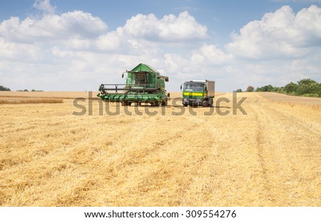 Gorna Oryahovitsa - June 20: Harvesting of grain harvest. Plow truck full of grain against the blue sky with white clouds on June 20, 2015 Gorna Oryahovitsa, Bulgaria