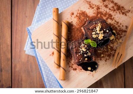 Cake chocolate brownies on with wafer stick wooden block background