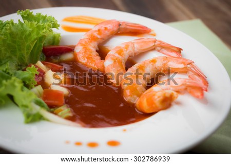 sweet and sour shrimp, prawn cocktail on dish and wooden table