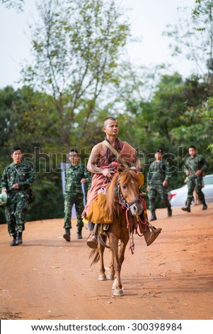 CHIANGRAI, THAILAND NOVEMBER 16,2014 priest ride a horse beg for food Festival Mexican sunflower  in the Doi Hua Mae Kham