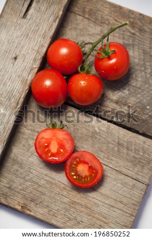 Tomatoes, cooked with herbs for the preservation on the old wooden table