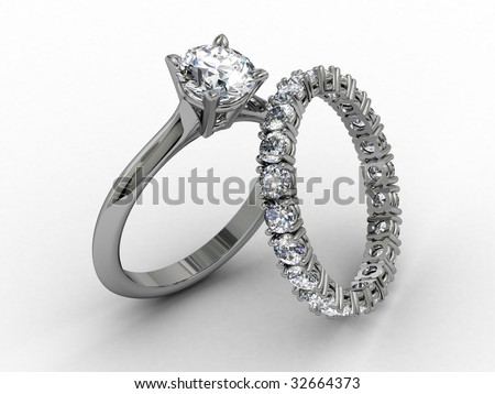 stock photo platinum diamond wedding ring set on matt white background