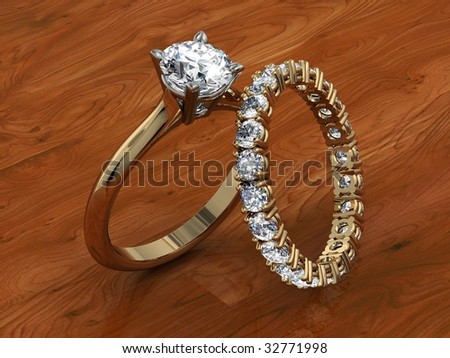 Diamond wedding ring set on gleaming wood background