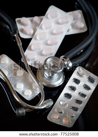 stethoscope and blister pills