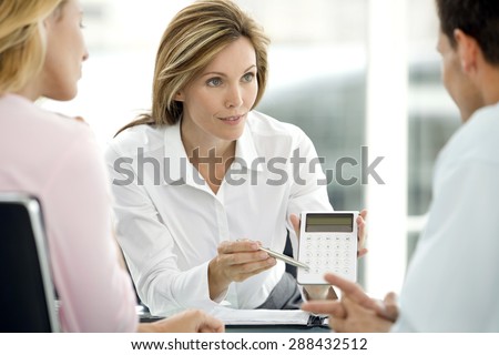 Couple dealing with a financial adviser at the bank