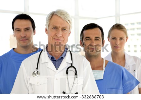 Medical staff standing behind senior male leader