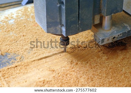 drill machine drilling a wood board