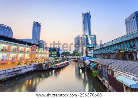 Bangkok, Thailand - February 8, 2015: Skyscraper and Pratunam pier in Bangkok; water transportation by speed boat is one of the alternative choice for solving the traffic congestion problem in Bangkok