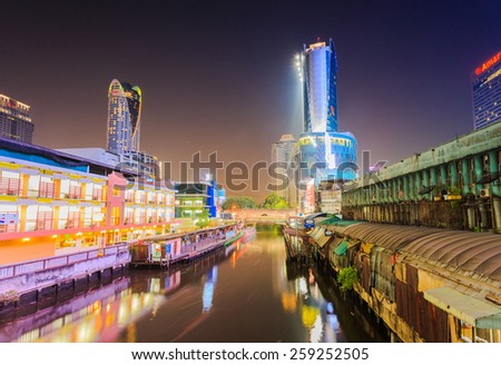 Bangkok, Thailand-February 8, 2015: Skyscraper and boat pier in Bangkok; water transportation by canal speed boat is one of the alternative choice for solving the traffic congestion problem in Bangkok