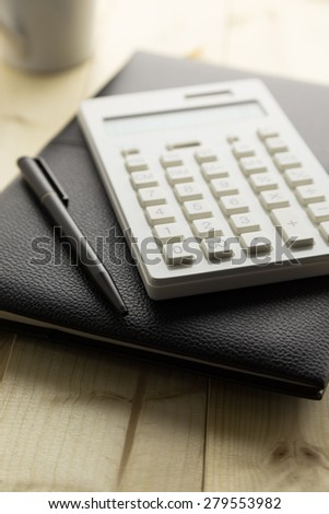 Calculator and Notebook on Desk