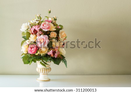 Bouquet flower in the vase on the brown background
