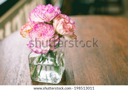 retro-vintage flower in vase on wooden table