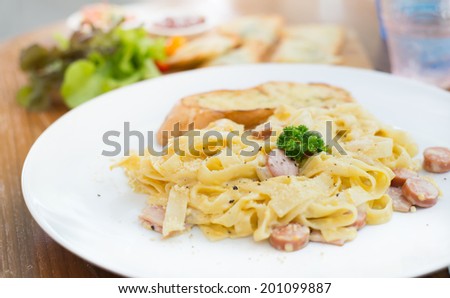 Spaghetti Carbon ara with ham and cheese on desk ,sunlight