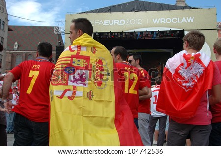 WROCLAW, POLAND - JUNE 8: Unidentified Spanish with national flag in Euro 2012 fanzone on June 8, 2012 in Wroclaw. The EURO 2012 will be held from June 8 - July 1, 2012 hosted by Poland and Ukraine.
