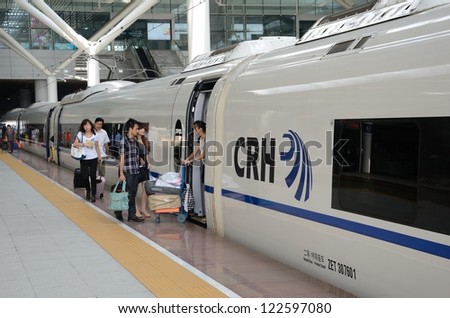 SHENZHEN, CHINA - SEPTEMBER 9:  Fast train in Shenzhen platform. Unidentified passangers board on September 9, 2012. With speed 300km/h train arrives Wuhan within 5 hours.