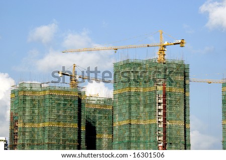 Chinese residential buildings under construction in Shanghai city. Work in progress with few cranks.