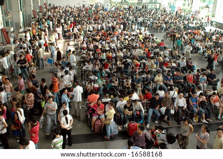 CHINA, SHUNDE TOWN, GUANGDONG PROVINCE - MARCH 10, 2006: crowd of Chinese people waiting at bus station.