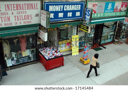 HONG KONG, KOWLOON - MAY 17, 2007: typical Hongkong street with money exchange, tailors and shops.