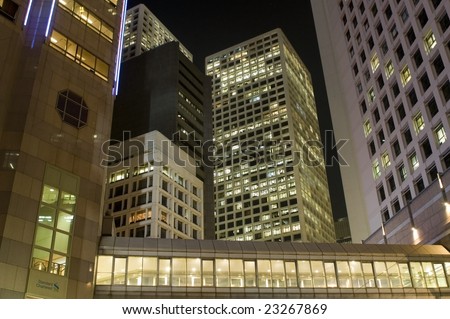 Hongkong city center with modern architecture by night. Bright office buildings with light inside.