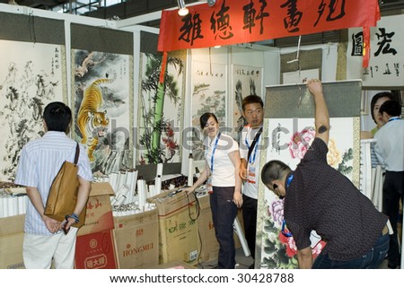 SHENZHEN, GUANGDONG - MAY 16: Visitors admire paintings exhibition and art auction at China International Cultural Industries Fair May 16, 2009 in Shenzhen, Guangdong China.