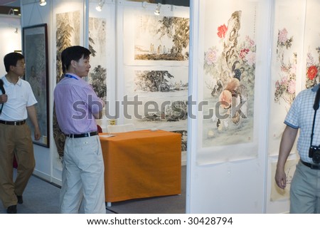 SHENZHEN, GUANGDONG - MAY 16: Visitors admire paintings exhibition and art auction at China International Cultural Industries Fair May 16, 2009 in Shenzhen, Guangdong China.