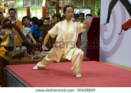 SHENZHEN, GUANGDONG - MAY 16: A student from Shenzhen Polytechnic performs kung-fu act at China International Cultural Industries Fair May 16, 2009 in Shenzhen, Guangdong China.
