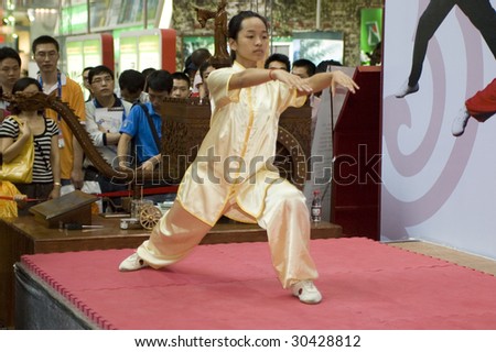 SHENZHEN, GUANGDONG - MAY 16: A student from Shenzhen Polytechnic performs kung-fu act at China International Cultural Industries Fair May 16, 2009 in Shenzhen, Guangdong China.