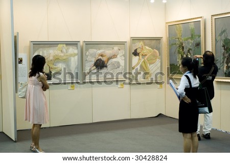 SHENZHEN, GUANGDONG- MAY 16: Visitors admire modern and ancient Chinese art paintings and graphics made in ink at China International Cultural Industries Fair May 16, 2009 in Shenzhen, Guangdong China