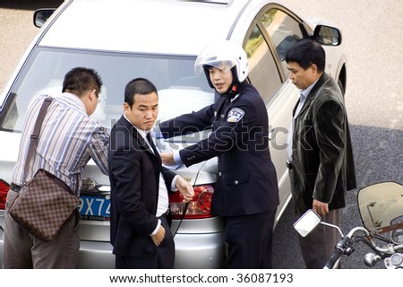 CHINA, SHENZHEN - DECEMBER 9: Policeman resolving car accident, even there are more and more cars in China, driving skills are getting worse. The accident happened on December 9, 2008 in Shenzhen, China.